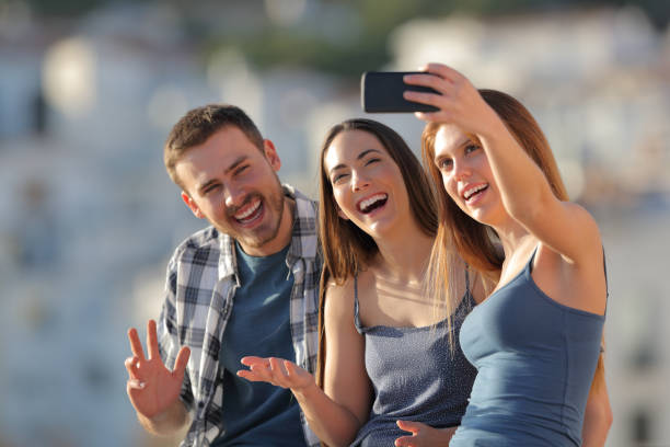 istock Three happy friends taking selfies in a town outskirts 1097445604