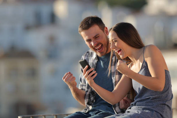 istock Excited couple or friends reading phone content 1097446696