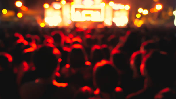 istock abstract colorful background audience in public concert. 1097448820