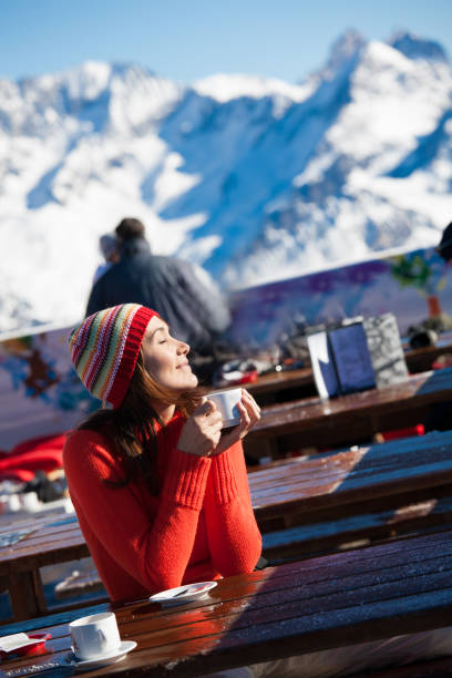 istock woman drinking a hot drink in the snow 1097450208