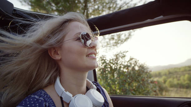 istock Woman having fun in a SUV. Wind in hair 1097455202