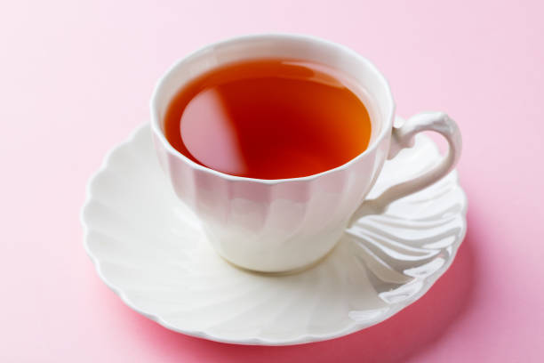 istock Tea in white cup on pink background. Close up. 1097456064