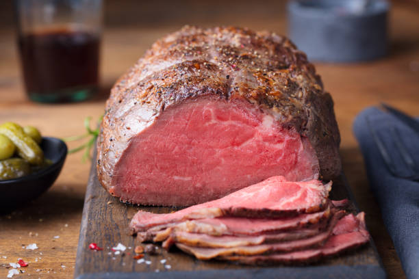 istock Roast beef on cutting board. Wooden background. Close up 1097458584