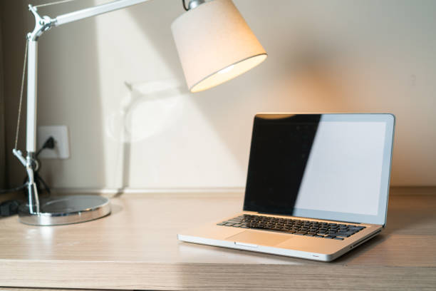istock Laptop on a desk with lamp 1097459160