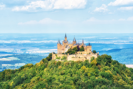 Hechingen, Germany - August  17, 2018: Hohenzollern Castle sits atop of mount Hohenzollern, just 31 miles south of the German city of Stuttgart, in Baden-Wurttemberg. It was the home of the Hohenzollern family which came to become German Emperors.