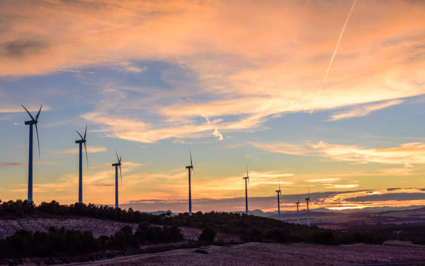 istock Wind plant at sunset for the generation of electrical energy 1097465912