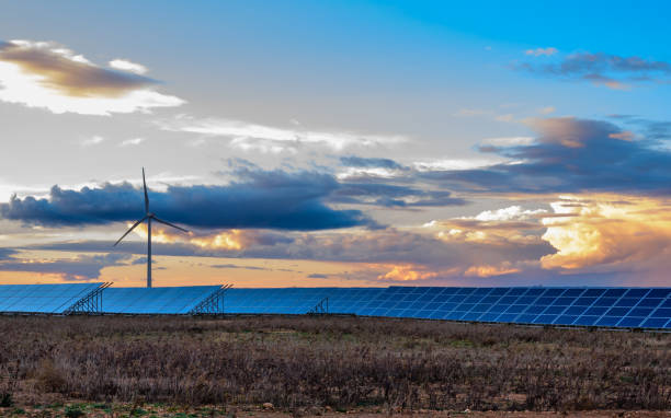 istock Photovoltaic and wind plant at sunset 1097465938