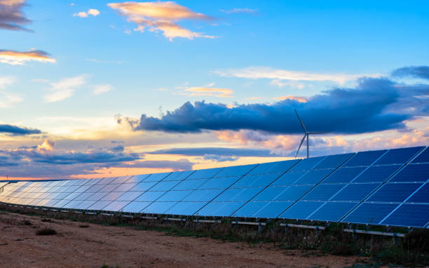 istock Photovoltaic and wind plant at sunset 1097465940