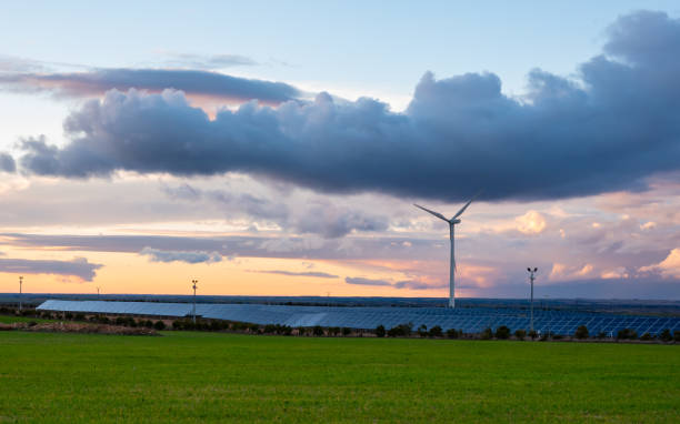 istock Photovoltaic and wind plant at sunset 1097465970