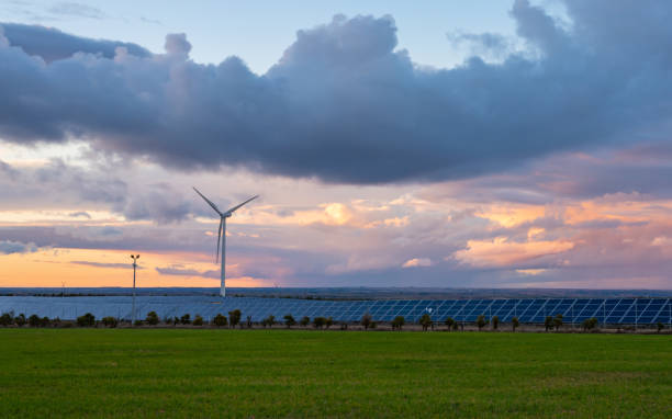 istock Photovoltaic and wind plant at sunset 1097465972