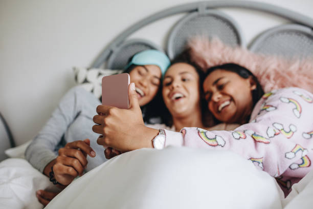 Three girl friends having fun during a sleepover