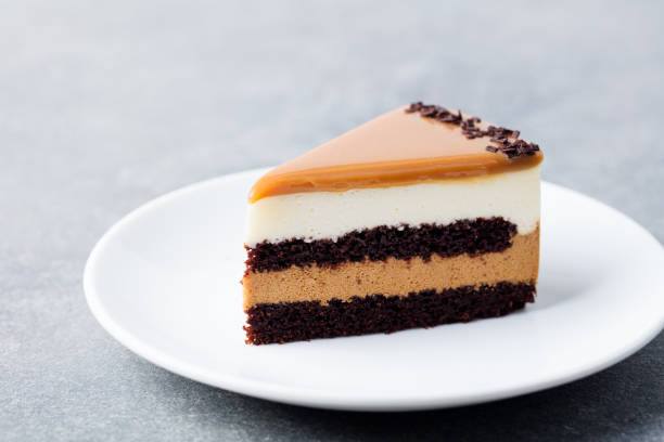 istock Caramel cake, mousse dessert on a plate. White background. 1097471878