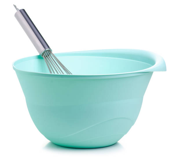 istock Green bowl and kitchen whisk corolla in hand 1097471922