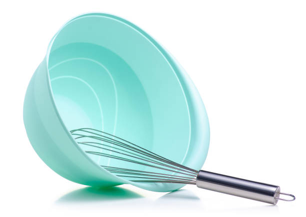istock Green bowl and kitchen whisk corolla in hand 1097471934
