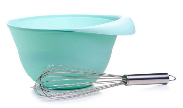 istock Green bowl and kitchen whisk corolla in hand 1097471960