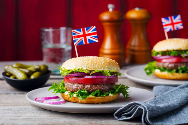 istock Burger with British flag on top. Wooden background. Copy space. 1097472084