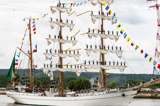 Parade of very old historical boats galleon on the river Seine for Armada, France ROUEN, FRANCE - JULY Circa, 2016. End of the Armada in Rouen, boats galleon ships on the river Seine. Differents naval transportation going to their country. Men woman standing up on the matts boat sail. Very important International festival in France, next in July 2019 armada stock pictures, royalty-free photos & images