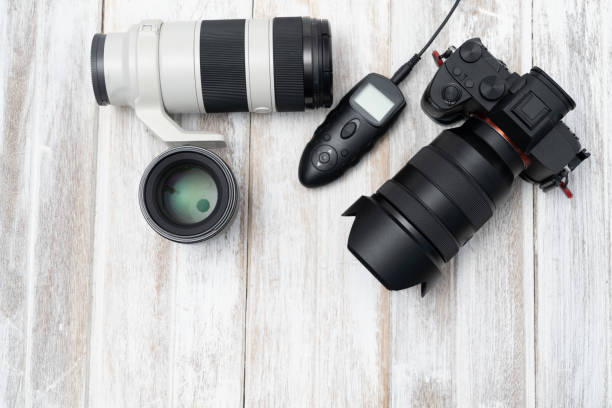 istock Top view of Digital Camera On White Wooden Background 1097473048
