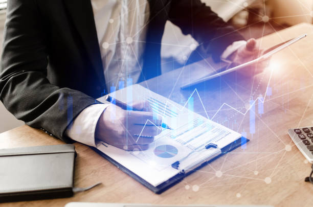 istock accountant investor analysis on financial reports and using mobile tablet with graphic candle stick graph chart of stock market investment trading for Forex trading, business, technology concept 1097474478