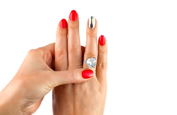 istock Female hands with red manicure wear a silver ring 1097474904