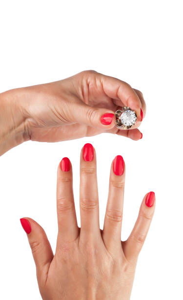 istock Female hands with red manicure wear a silver ring 1097475928