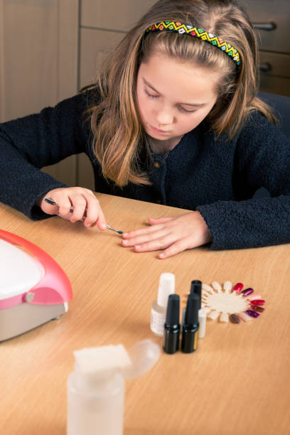 istock Young girl with nail file 1097478140