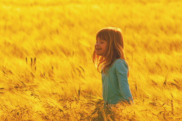 istock Girl walking in the wheat field 1097482516