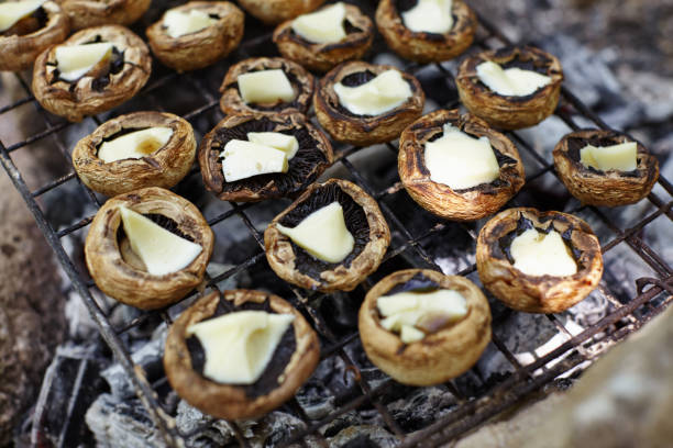 Mushrooms stuffed with cheese on barbeque grill