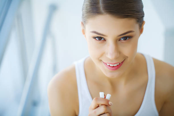 istock Beautiful young woman eating chewing gum, smiling 1097486830