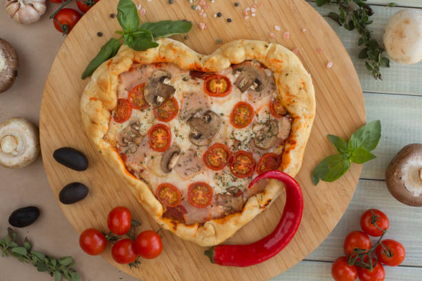 istock Pizza heart shaped on wood 1097490492