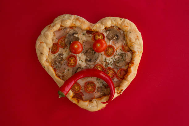 istock Pizza heart shaped on red 1097490560