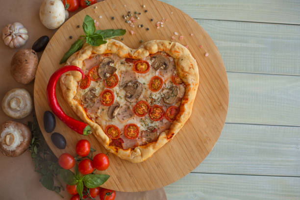 istock Pizza heart shaped on wood 1097490600