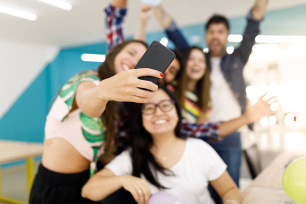 istock Happy friends talking a selfie in the office 1097490896