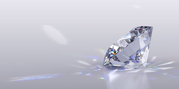 Side view of a round cut diamond with caustics rays on light gray background