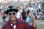 Cute music festival male attendant giving a peace sign