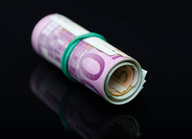 istock European paper money in roll on black background. 1097496568