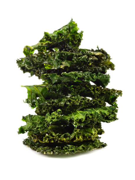 Stack of healthy kale chips isolated on white stock photo