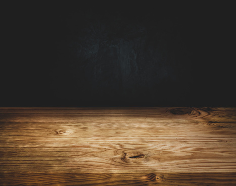 Empty wood table top counter on dark wall background.For create product display or design key visual layout