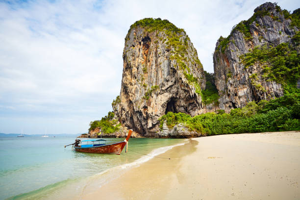 istock Long tail boat moored by a tropical island. 1097500538