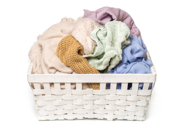 istock Clothes in a laundry wooden basket isolated on white background 1097501646