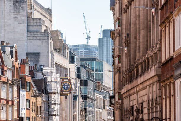 london, uk view of road in center of downtown financial district city with old architecture strand streeet and construction cranes in summer - strand imagens e fotografias de stock