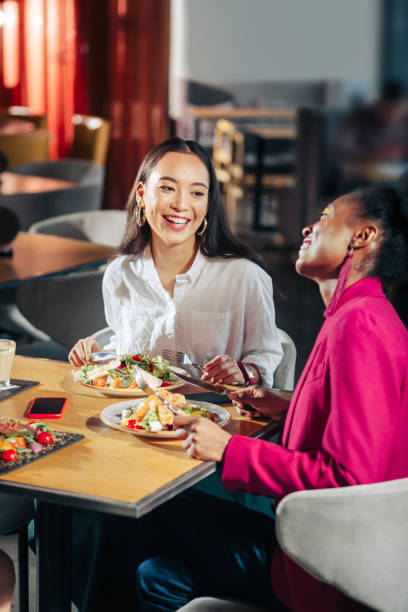 istock Friends laughing while communicating in a big restaurant 1097507670