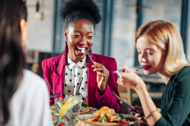 istock Three stylish appealing women having delicious dinner together 1097507686