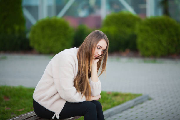 istock Woman stressed from work while sitting outdoors, press from colleagues 1097512028