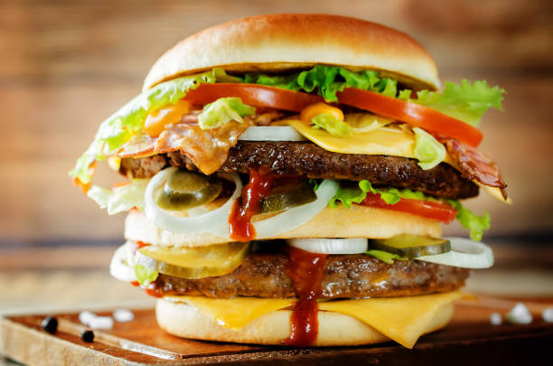 istock Meat Burger with salad, cheese, tomato and ketchup sauce 1097512258