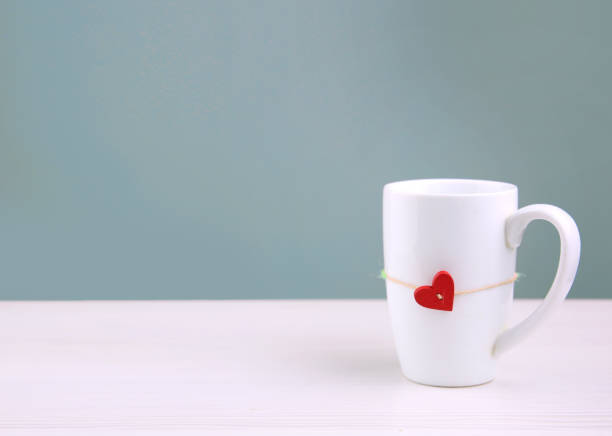 Valentine's day background.White mug with heart on table empty copy space.Mother's day.Father's day.