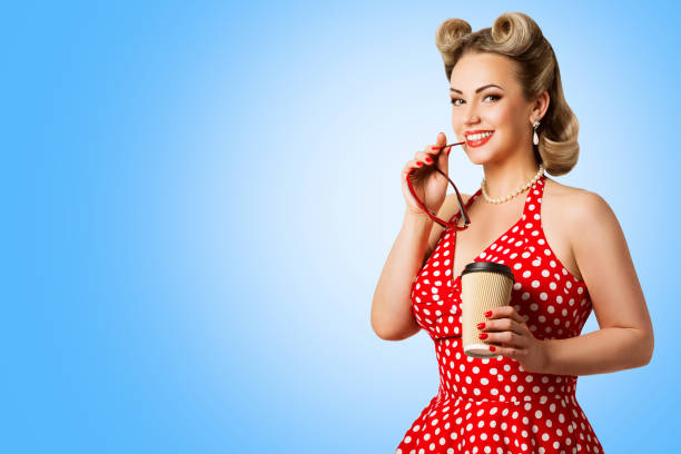 Retro Fashion Model Red Polka Dots Dress, Woman Pinup Beauty Style, Happy Girl Holding Paper Cup Retro Fashion Model Red Polka Dots Dress, Woman Pinup Beauty Style, Happy Girl Holding Paper Cup over blue background 40s pin up girls stock pictures, royalty-free photos & images