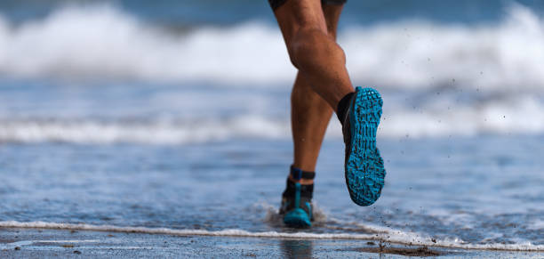 istock Athlete runner running on waves of sea 1097518086