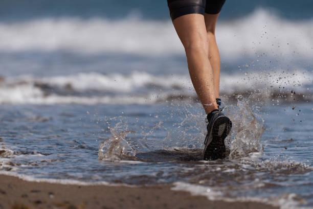 istock Athlete runner running on waves of sea 1097518160