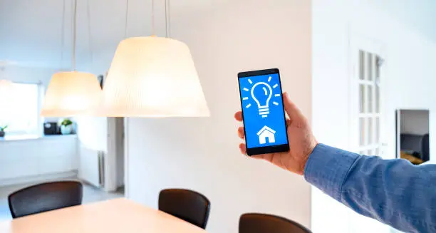 Photo of Mobile phone shows app to control light in smart home